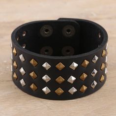 Designed by Deepika Lohani in India, this fitted cuff bracelet pairs silvery studs with shimmering golden accents. Indian artisans hand craft the bracelet from a wide strip of black leather, embellishing the cuff with brass- and nickel-plated iron studs. Leather Cuff Bracelet, Hand Craft, Leather Cuffs Bracelet, Grow Together, Studded Leather, Leather Cuffs, Cuff Bracelet, Cuff Bracelets, Leather Bracelet