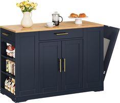 a blue kitchen island with two trays on it and some flowers in the vase