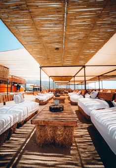 rows of beds are lined up on the roof of a building with straw bales