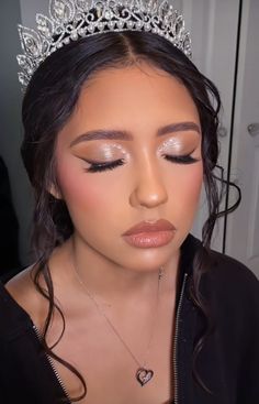 a woman wearing a tiara and makeup