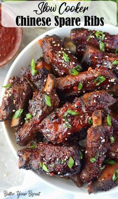 a bowl filled with chinese spare ribs and garnished with sesame seeds on top