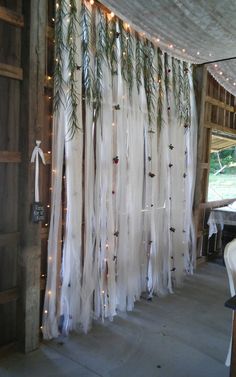 the curtain is decorated with lights and greenery