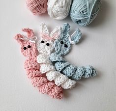 three crocheted animals sitting next to each other on top of a white surface