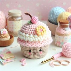 crocheted cupcakes and other crafting items on a table