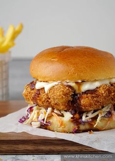 a fried chicken sandwich with coleslaw and mayonnaise