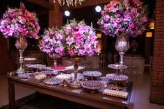 a table topped with lots of desserts and flowers