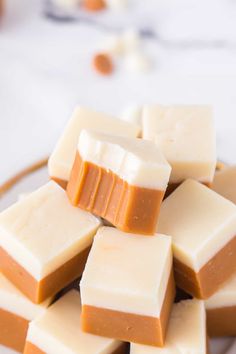 several pieces of white and brown fudge on a plate next to some candy canes