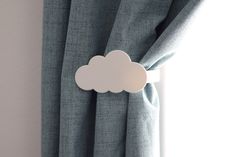 a white cloud hanging from the side of a curtain