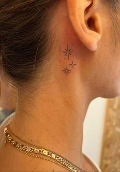 a woman with a small star tattoo on her left side behind her ear, looking to the right