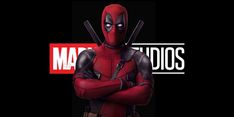 a deadpool character standing with his arms crossed