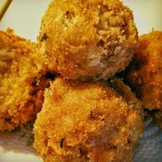 some fried food sitting on top of a white plate