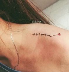 the back of a woman's neck has a tattoo that says love on it