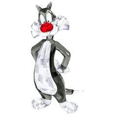 a glass figurine of a cat with red nose and tail, standing on one leg