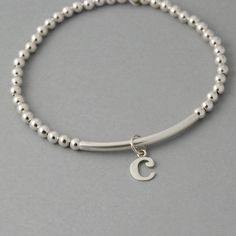 This is my new go to bracelet. Made for easy wear with high quality stretchy cord. Sterling silver beaded bracelet with a sterling bar. Silver initials dangle perfectly. Wear it alone or layered up! So cute. Listing is for one bracelet. **Please leave initial choices in notes at checkout** Comes in a Organza bag, gift box available or additional $2 PLEASE NOTE WHEN ORDERING, MEASURE YOUR WRIST, THEN ADD 1/2 INCH FOR A COMFORTABLE FIT. bracelet is adjustable by 1/2 inch. x-small 5-6 inches small Minimalist Silver Hypoallergenic Stretch Bracelet, Silver Hypoallergenic Minimalist Stretch Bracelet, Silver Hypoallergenic Stretch Bracelet For Everyday, Minimalist Hypoallergenic Silver Stretch Bracelet, Personalized Silver Beaded Bracelets For Everyday, Silver Minimalist Stretch Bracelet As Gift, Everyday Stackable Sterling Silver Stretch Bracelet, Everyday Sterling Silver Stackable Stretch Bracelet, Everyday Stackable Sterling Silver Bracelet