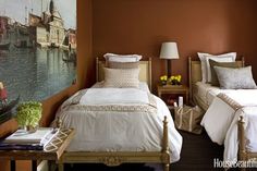 two beds in a room with brown walls and white bedding, one has a painting on the wall