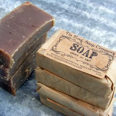 three soap bars stacked on top of each other next to a package of soaps