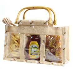 a bag with some food in it and a honey jar on the inside, sitting next to another bag