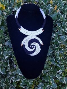 "This necklace is 100% handcrafted using white and black beads. Measurements: 18 inches around the neck. Pendant: 4\" Perfect for weddings, African themed events, traditional events etc. **Buy multiple items and pay shipping for 1 item only.The rest ships free. More neckleces here; https://www.etsy.com/shop/TribalTess?ref=seller-platform-mcnav&section_id=21306083 Back to my shop; https://www.etsy.com/shop/TribalTess?ref=seller-platform-mcnav" Unique White Adjustable Necklace, Handmade White Spiral Necklaces, Bohemian White Jewelry With Black Beads, Unique White Adjustable Beads, Unique White Round Bead Necklaces, Unique White Jewelry With Black Beads, Unique White Beaded Necklace, White Bohemian Necklace With Black Beads, White Beaded Necklaces With Black Beads As Gift