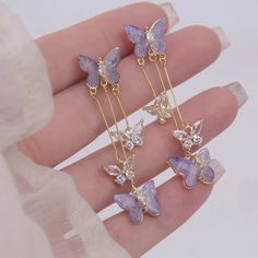 🦋 Elevate Your Style with Our Handcrafted Butterfly Earrings 🦋 Add a touch of whimsy and elegance to your accessory collection with our stunning Long Butterfly Earrings. Handcrafted with exquisite attention to detail, these earrings feature intricately designed butterfly charms that dangle gracefully, capturing the beauty and lightness of nature. Made from high-quality materials, including hypoallergenic stainless steel and shimmering crystals, these earrings are both durable and gentle on sensitive skin. Each butterfly charm is thoughtfully crafted to bring out a radiant sparkle, making them a perfect addition to any casual or formal outfit.  The delicate chains allow for fluid movement, creating a mesmerizing effect that is sure to draw compliments. Ideal for both everyday wear and spe Aesthetic Jewellery, Fashion Purple, Romantic Earrings, Pretty Jewelry Necklaces, Wholesale Earrings, Earrings Aesthetic, Mobile Cover, School Jewelry, Aesthetic Jewelry