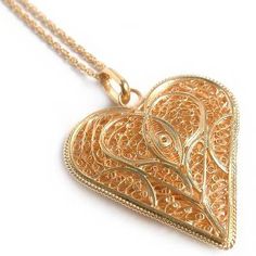 Giuliana Valz-Gen crafts a filigree heart to wear on a spiral chain. The beautiful pendant is crafted of silver and bathed in 21k gold. .925 Sterling silver Filigree Pendant Necklace, Spiral Pendant, Spiral Necklace, Filigree Heart, Heart Shaped Pendant Necklace, Heart Shaped Pendant, Filigree Necklaces, Filigree Jewelry, Necklaces Gold