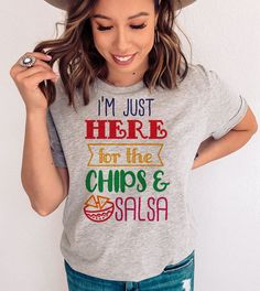 This "I'm Just Here For The Chips & Salsa" design is the perfect, fun Cinco De Mayo shirt for anyone that loves drinks and to celebrate! Novelty Multicolor Tops With Funny Print, Multicolor Novelty Tops With Funny Print, Fun Crew Neck Tops With Funny Print, Crew Neck Tops With Funny Print, Novelty Tops With Funny Print And Crew Neck, Fun Crew Neck Shirt With Funny Text, Novelty Crew Neck Top With Funny Text, Fun Slogan Crew Neck Top, Fun Crew Neck Shirt With Letter Print