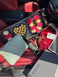 a car filled with lots of different types of flowers and other things in the back seat