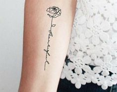 a woman's arm with a tattoo that reads, i love you and a rose on it