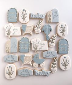 baby shower cookies are arranged on a white surface