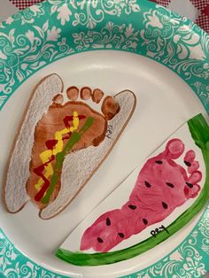 a plate with some food on it and a handprinted foot in the middle