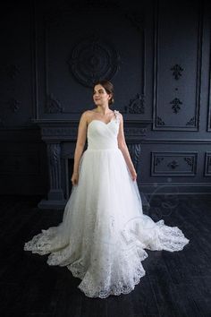 a woman in a white wedding dress posing for the camera with her hands on her hips