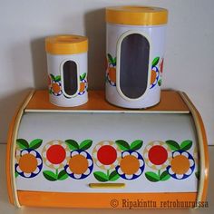 an orange and white toy kitchen set with matching containers on the counter top, sitting next to each other