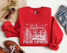 Believe The Polar Express Sweatshirt, North Pole Christmas Sweatshirt, Christmas Trip Hoodie Welcome to ApparelByMoliva https://apparelbymoliva.etsy.com 🔹 High quality and super soft comfortable sweatshirts are prepared with new technology DTF and a professional quality heat press.   🔹  HOW TO PLACE AN ORDER? 🔹   Please check the size, color and theme of all images in this listing. 🔸 Choose the size and color of the shirt from the menus. 🔸 Fill the empty box with your design color for personalization. Please refer to the photos in this listing to see what colors are available.     (Example: Design Color Black) 🔸 Choose the amount 🔸 Add to Basket 🔸 Proceed to checkout   Note1: Please ask for sizes and colors that are not in our size chart.   Note2: Durable 50% Cotton/50% Polyester B Polar Express Family Shirts, Polar Express Tshirt Ideas, Polar Express Shirts, Polar Express Sweatshirt, Christmas Vacation Sweaters, Polar Express Pajamas, Polar Express, Christmas Travel, Christmas Sweatshirts