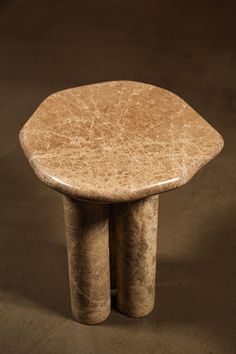 two small stools sitting on top of each other in front of a black background