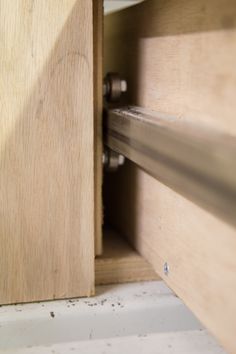 a close up of a wooden cabinet door with the handle on it's latch