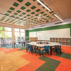 an empty classroom with tables and chairs in it