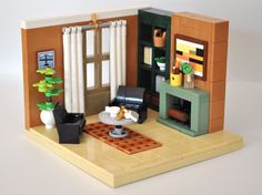 a lego model of a living room with furniture and decor on the floor, in front of a window