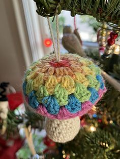 a crocheted ornament hanging from a christmas tree