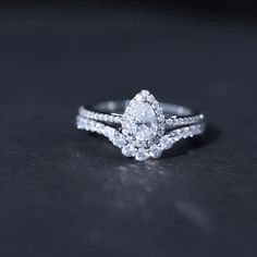 a close up of a diamond ring on a black surface