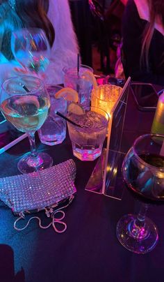 several glasses of wine on a table at a party