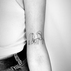 a woman with a tattoo on her arm