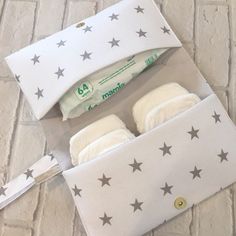 a pair of baby diapers in a white bag with stars on it and a toothbrush