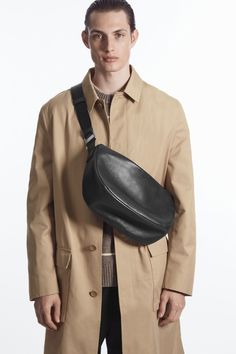 Debuting in the Autumn Winter menswear collection, this refined bag is crafted from premium chrome-free leather with a light layer of padding. It's designed in a subtle crescent shape that will tuck perfectly under your arm when worn crossbody and features silver-tone hardware, an internal slip pocket and a wide webbing strap that can be adjusted to your preference. Zip closureCOS supports responsible manufacturing via the Leather Working Group Shell: 100% Leather, Lining: 100% Organic cotton Height: 19.6cm, Depth: 12.5cm Versatile Business Saddle Bag With Removable Pouch, Modern Business Saddle Bag With Removable Pouch, Leather Shoulder Bag With Removable Pouch For Commuting, Commuting Leather Shoulder Bag With Removable Pouch, Modern Textured Leather Saddle Bag For Travel, Modern Soft Leather Saddle Bag, Designer Leather Shoulder Belt Bag, Leather Shoulder Bag For Commuting, Modern Leather Crossbody Belt Bag