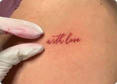 a woman's stomach with the word love written on it, in red ink