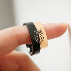 a person wearing a ring with writing on it