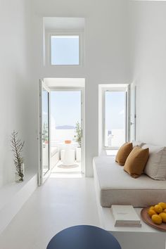 a living room filled with furniture and white walls