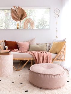 a living room filled with furniture and pillows