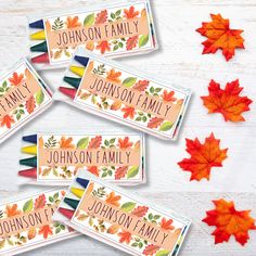 four personalized crayons with autumn leaves on them and the name of each child