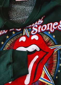 START ME UP! Soft, slouchy raglan crew sweatshirt featuring colorful Rolling Stones US Tour 1981 graphics at front. Lightweight (not bulky) with a classic fuzzy lining inside. Vintage hunter green colorway. Features: Slouchy, relaxed fit sweatshirt Crew neckline Long raglan sleeves Ribbed cuffs on sleeve Banded hem Colorful Rolling Stones graphics at front Hunter green colorway Lightweight with fuzzy lining inside Officially licensed Ethically made in California Brand & Fabric Content: Brand: Da Ankle Length Skirt, Ragged Priest, Nine Lives, Skirt Jumpsuit, Sock Gifts, Workout Sweatshirt, Girl Bands, Crew Sweatshirts, Hunter Green