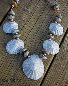 the necklace is made with shells and beads