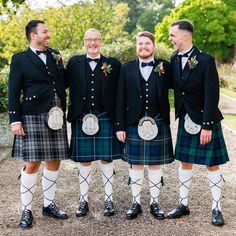 a group of men in kilts standing next to each other